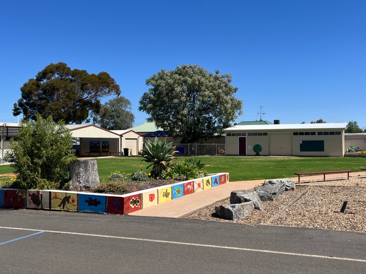 Basketball court and grass area in the playground