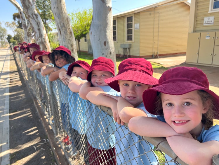 Students leaning on school fence