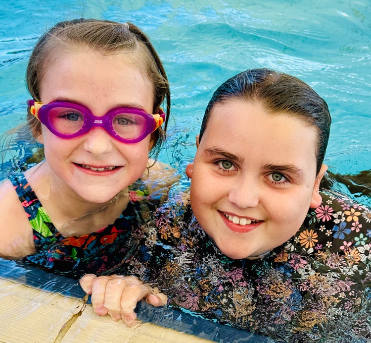 Two girls in pool at swimming carnival