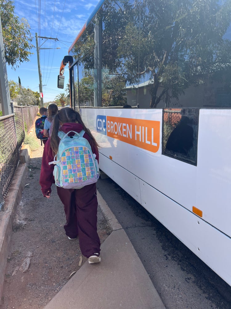 Students walking onto school bus