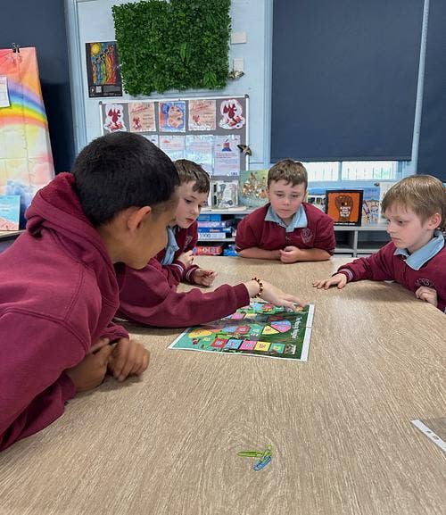Students playing board game